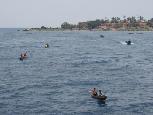 several small boats arriving from the village