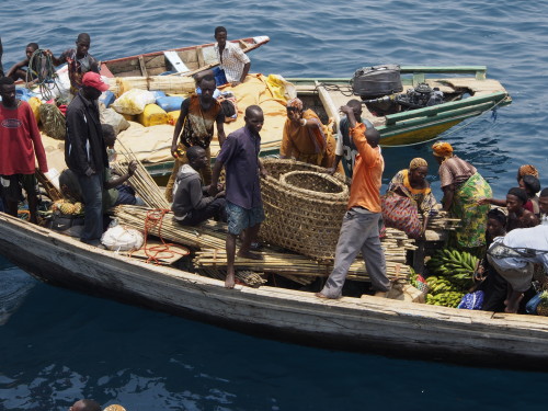 people and cargo on small boat