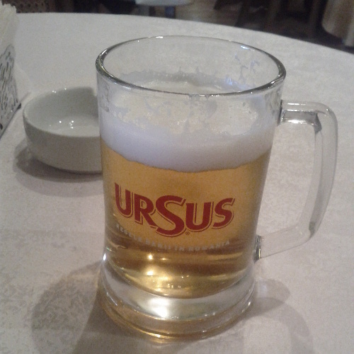 a glass of ursus beer
